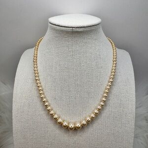 Vintage graduated faux pearl necklace with crystal set clasp.